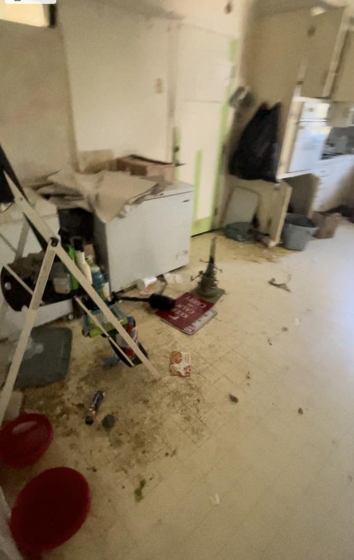 Woodworth kitchen at acquisition: abandoned contents and soiled flooring